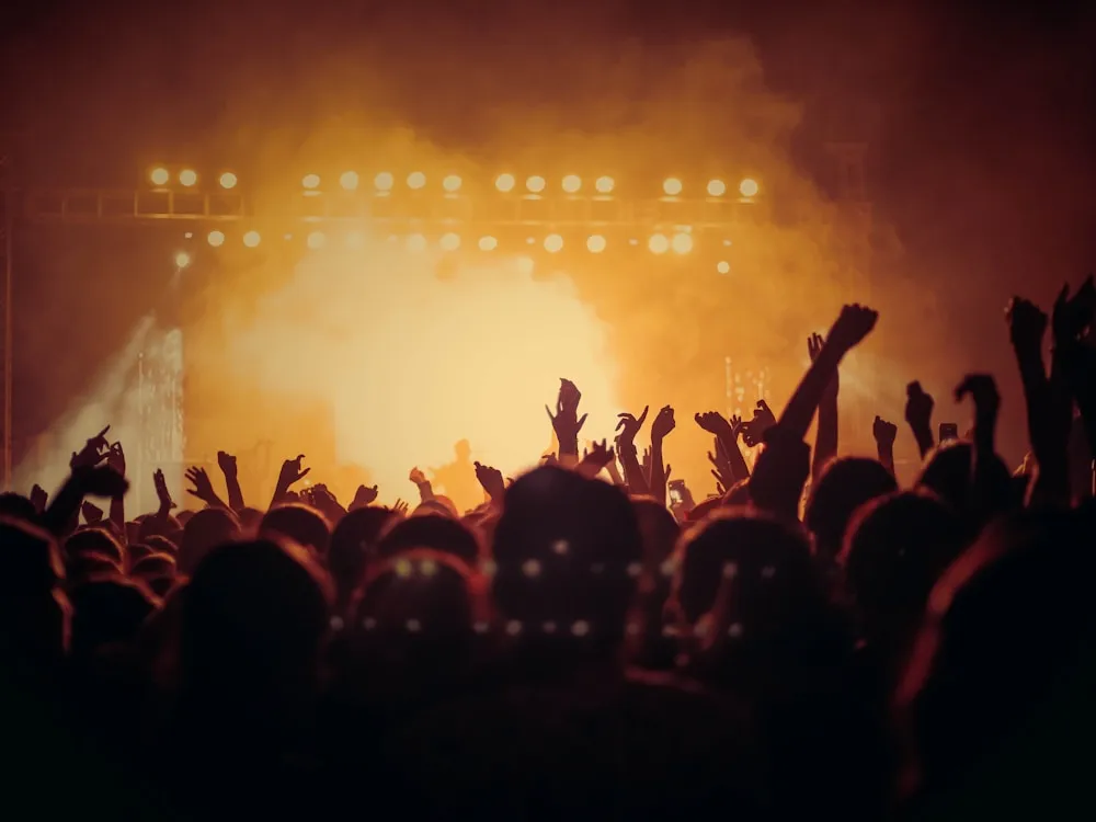 Production professional mixing live audio at a lighting-lit event console